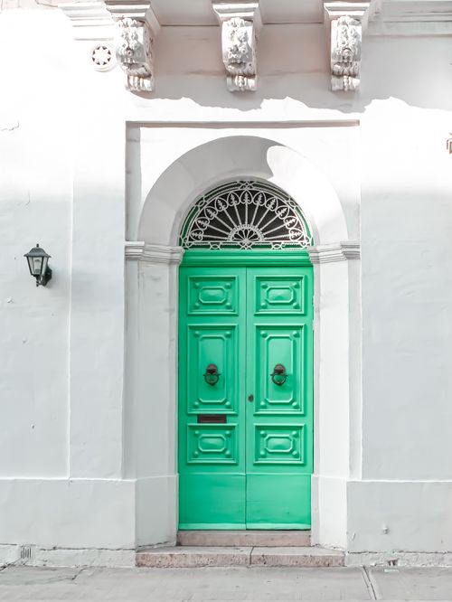 Free Vibrant green door set into a white colonial facade, showcasing Mediterranean charm. Stock Photo