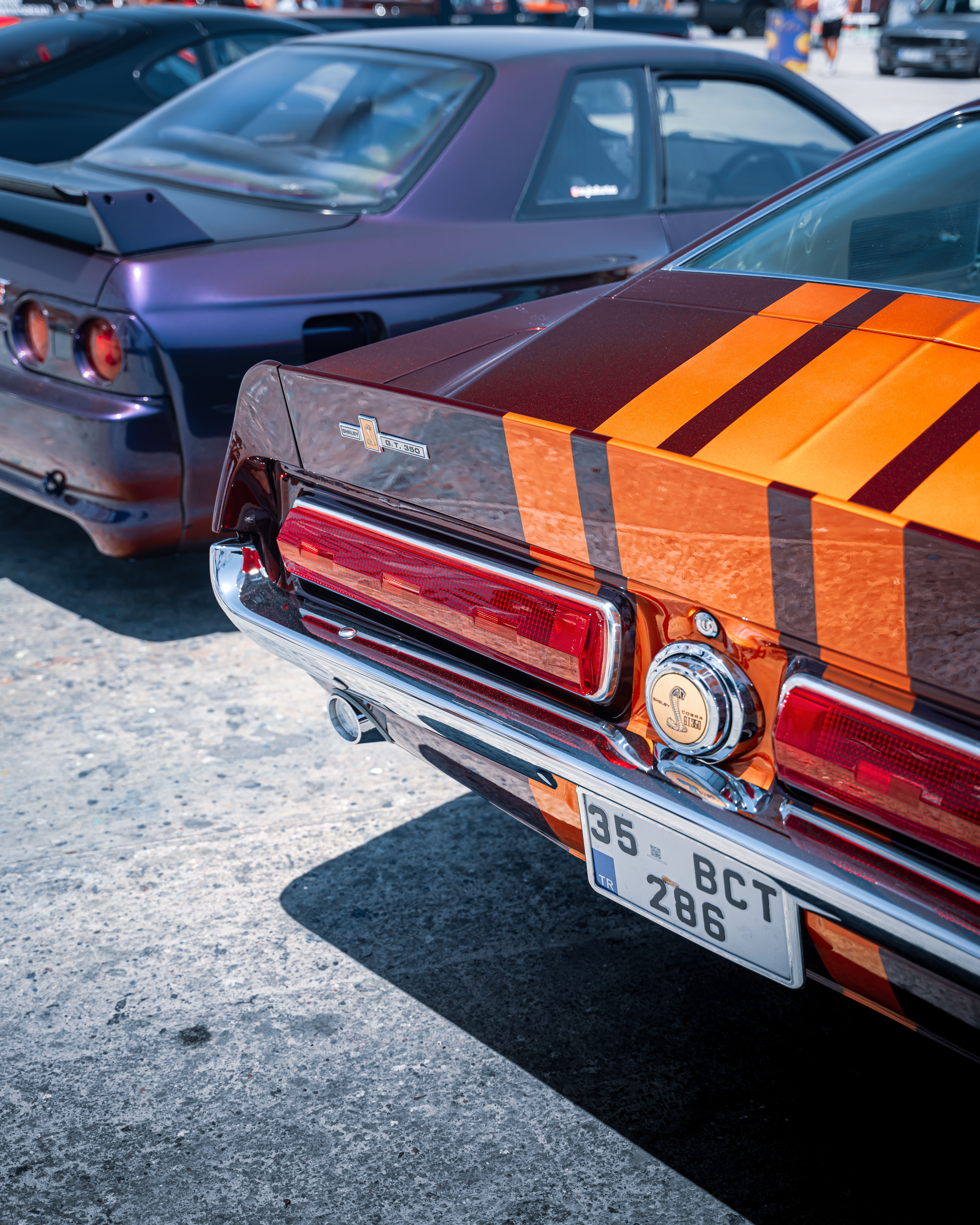 Vintage and modern cars displayed at an outdoor car meet in Izmir, Türkiye.