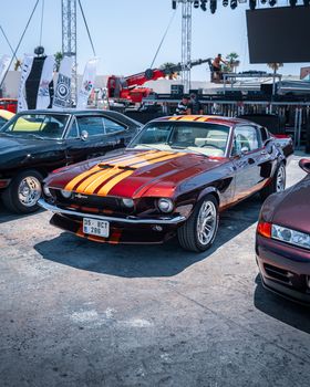 Vintage cars showcased at Alaçatı İzmir automobile exhibition. Bright sunny day, exterior setting.