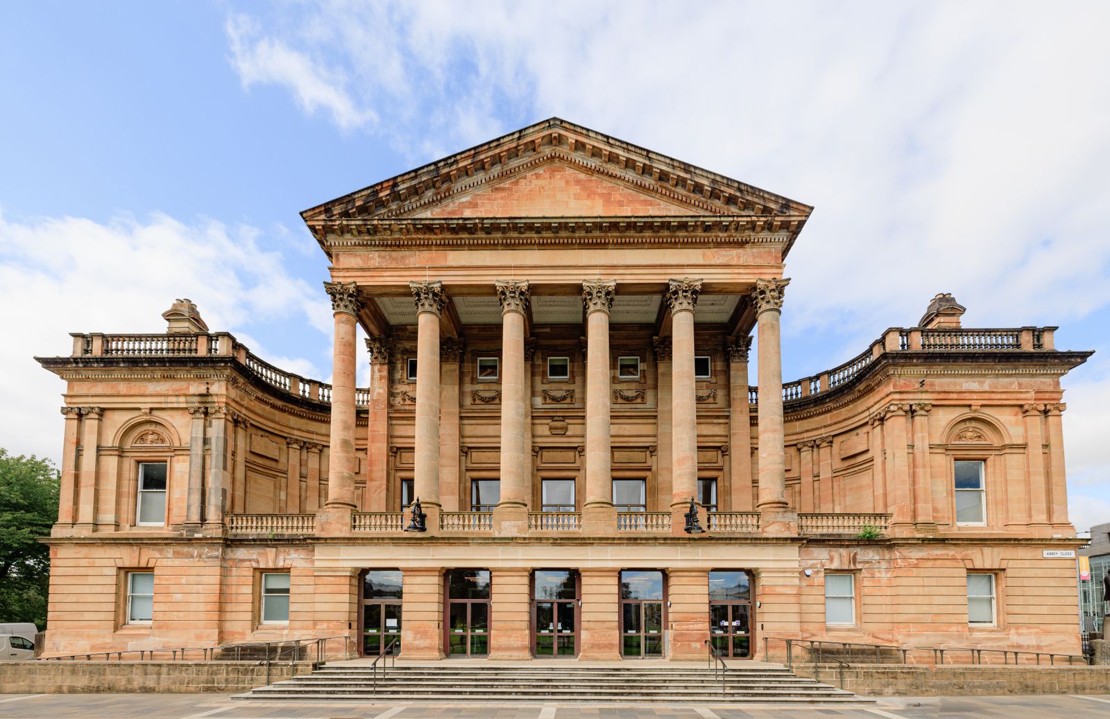 Front view of Paisley Town Hall, a neoclassical building in Renfrewshire, under a clear blue sky