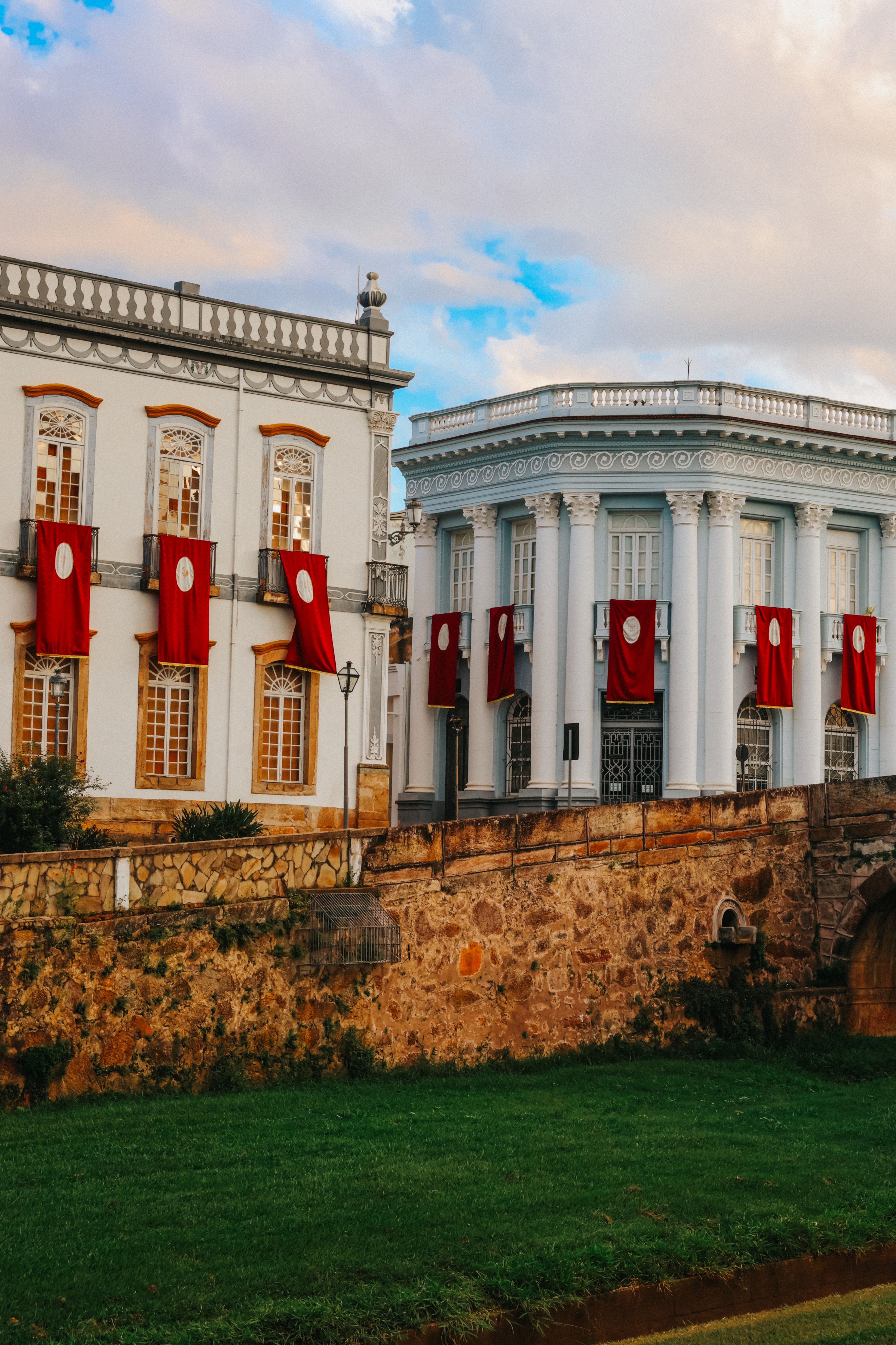 Historic buildings with red banners in daylight · Free Stock Photo