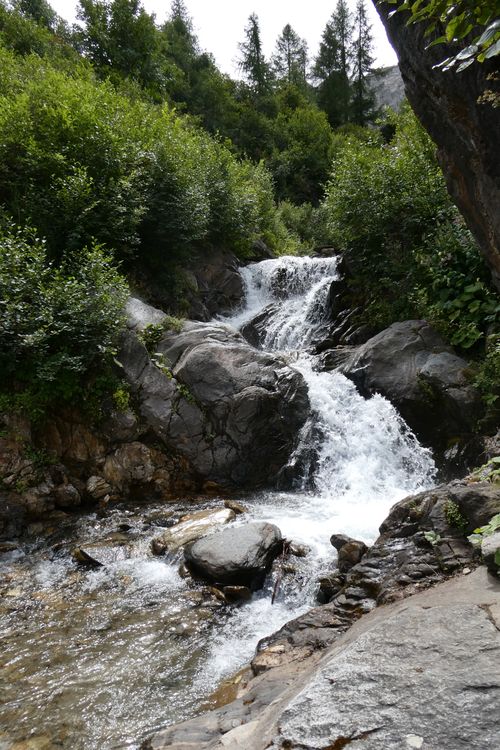 Free Beautiful waterfall cascading through a lush forest landscape in Lithuania. Stock Photo