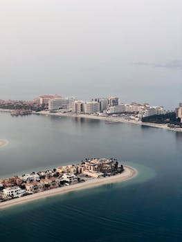 Explore the stunning aerial view of Dubai's Palm Jumeirah, showcasing luxury architecture and serene waters.