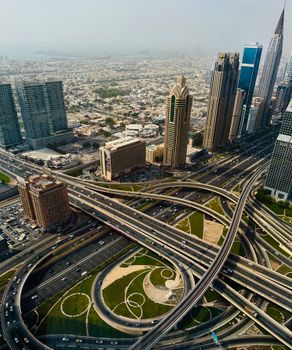 Stunning aerial view of Dubai's Sheikh Zayed Road featuring modern skyscrapers and intricate highway network.