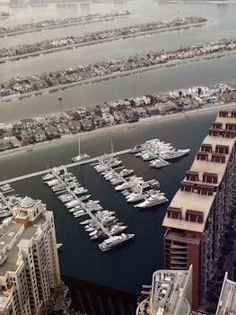 Stunning aerial view of Dubai Marina with luxury yachts and waterfront homes in the United Arab Emirates.