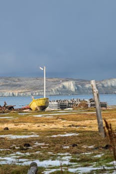 A yellow boat on a scenic coastline in Puerto Almanza, Argentina.