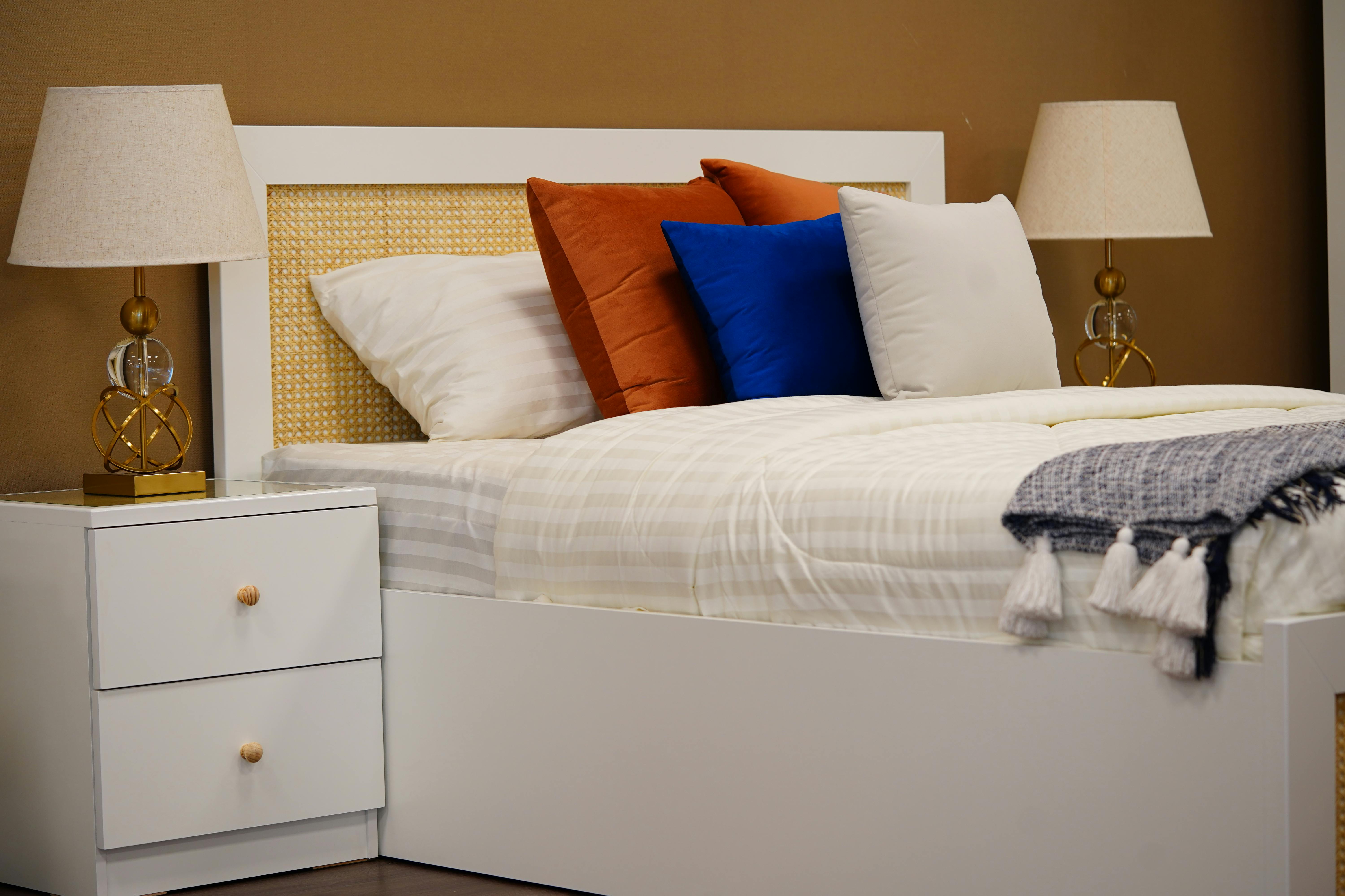 Cozy modern bedroom with elegant decor and warm lighting featuring neutral tones and stylish furniture.