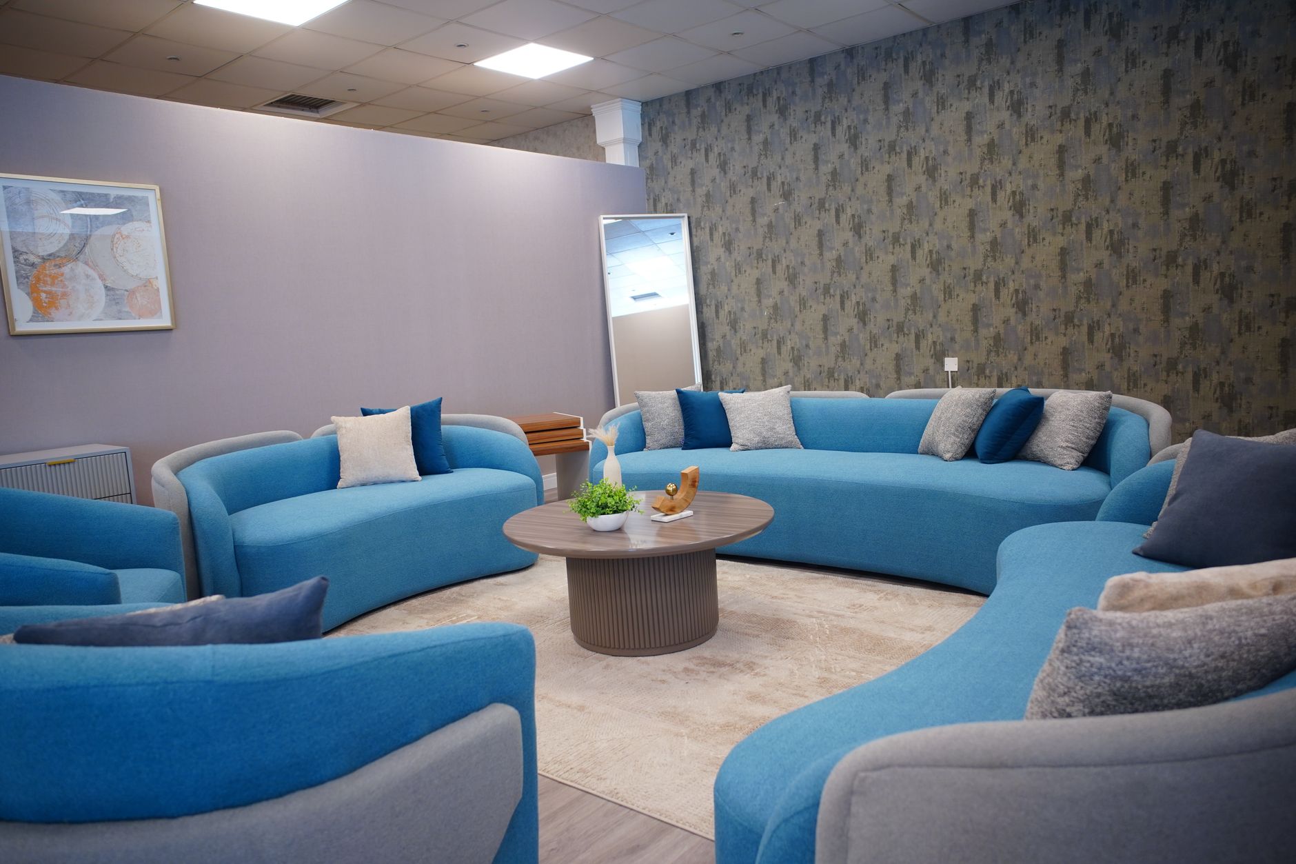 Elegant living room with contemporary blue sofas and cozy decor.