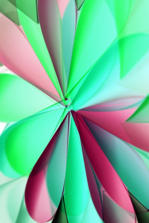 Free Vibrant paper origami creating a dynamic abstract pattern with green and pink hues. Stock Photo
