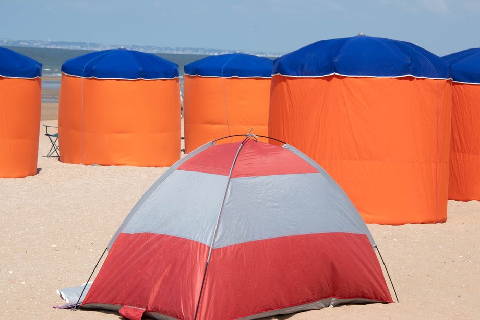 Bright beach tents on a sunny day in Houlgate, Normandie, France.