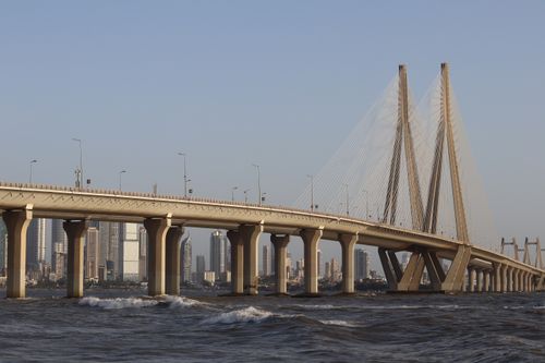 Free View of the iconic Bandra-Worli Sea Link in Mumbai, showcasing modern architecture against a city skyline. Stock Photo