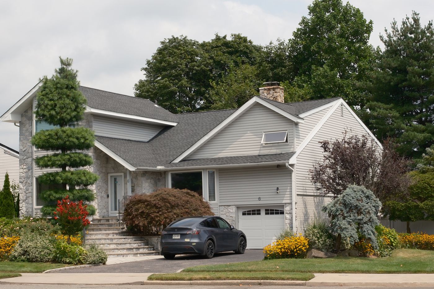 Suburban house with a car parked in the driveway