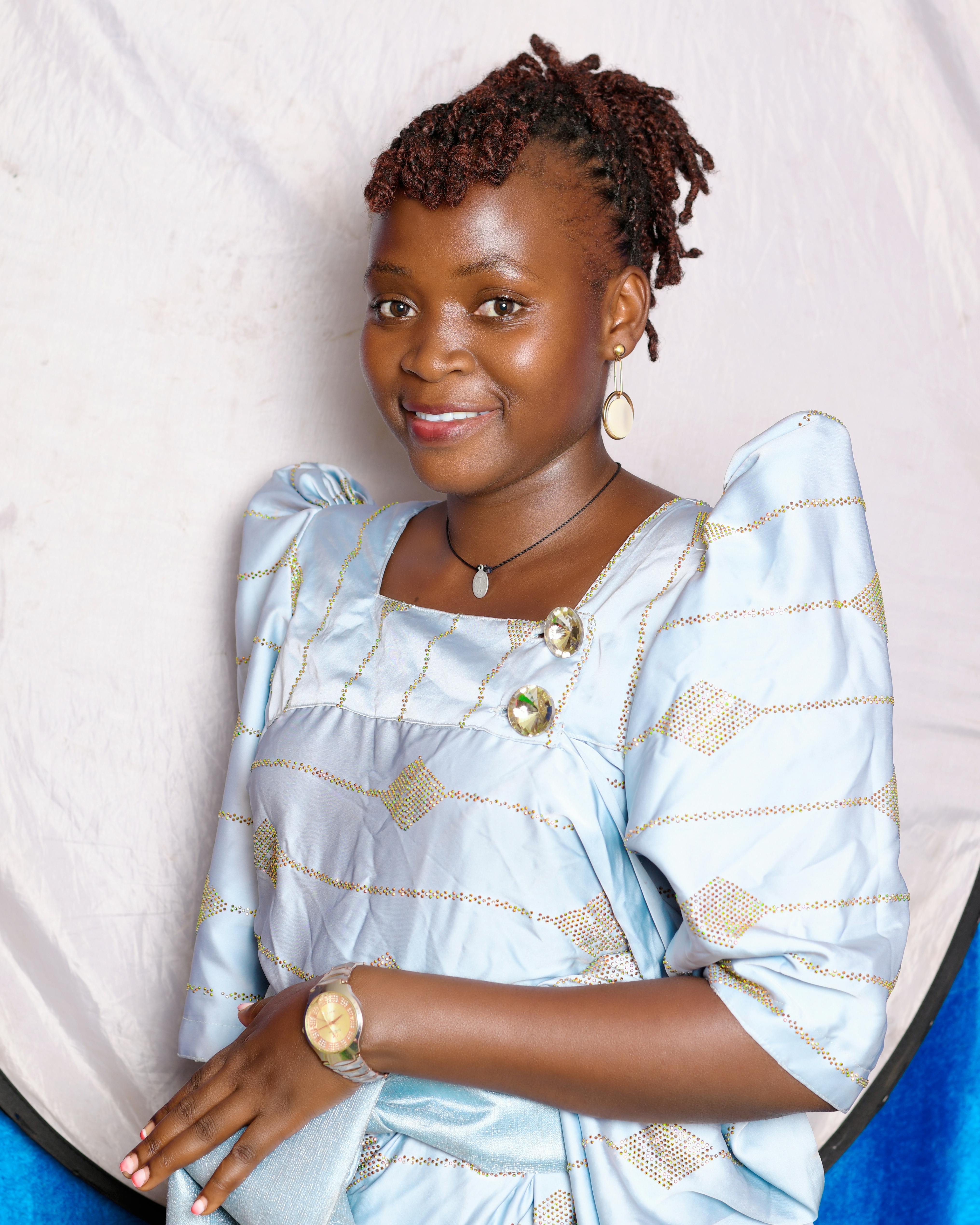 Charming woman in traditional attire with a warm smile, captured in a studio setting.