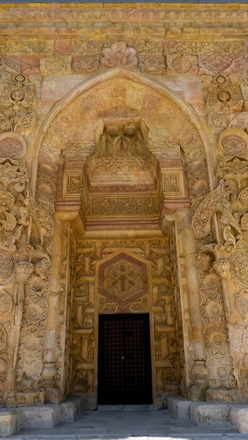 Free Detailed view of an ancient carved stone entrance with rich ornamentation. Stock Photo