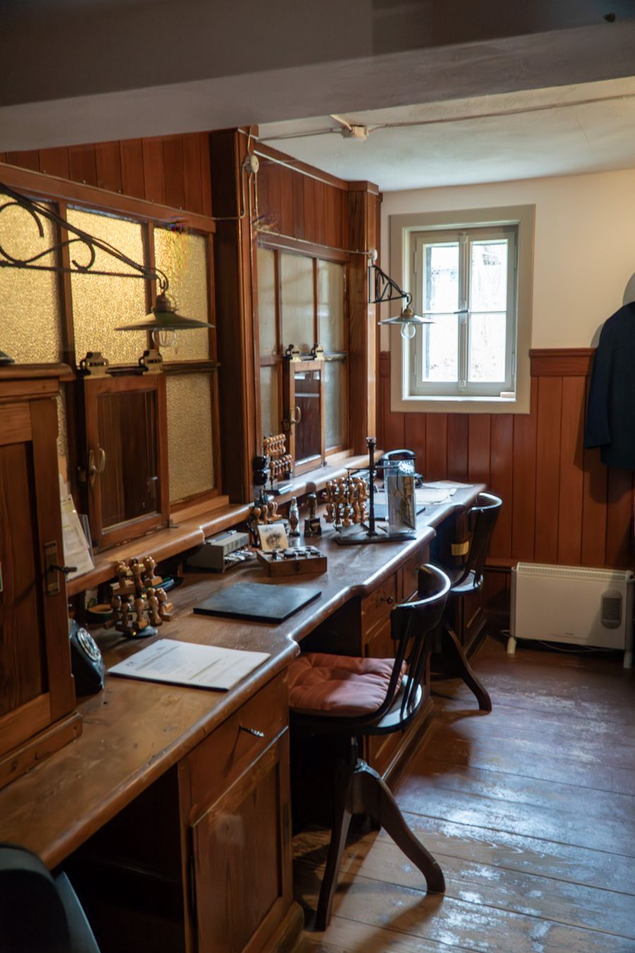 The original workshop office, with a wooden desk, early equipment and a large window