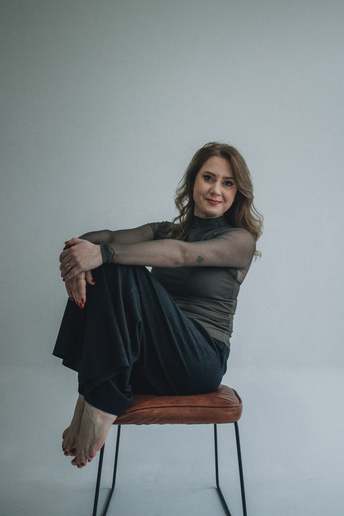 Elegant Woman Posing on a Chair in Studio · Free Stock Photo