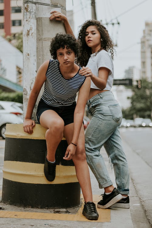 Free Photo of Two Women Posing on Sidewalk Stock Photo