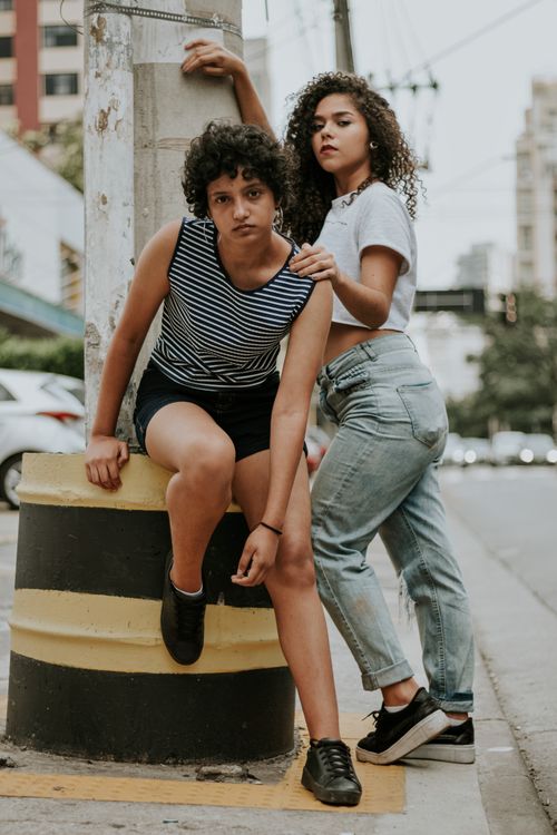 Free Two models posing in casual urban fashion outdoors on a city street. Stock Photo
