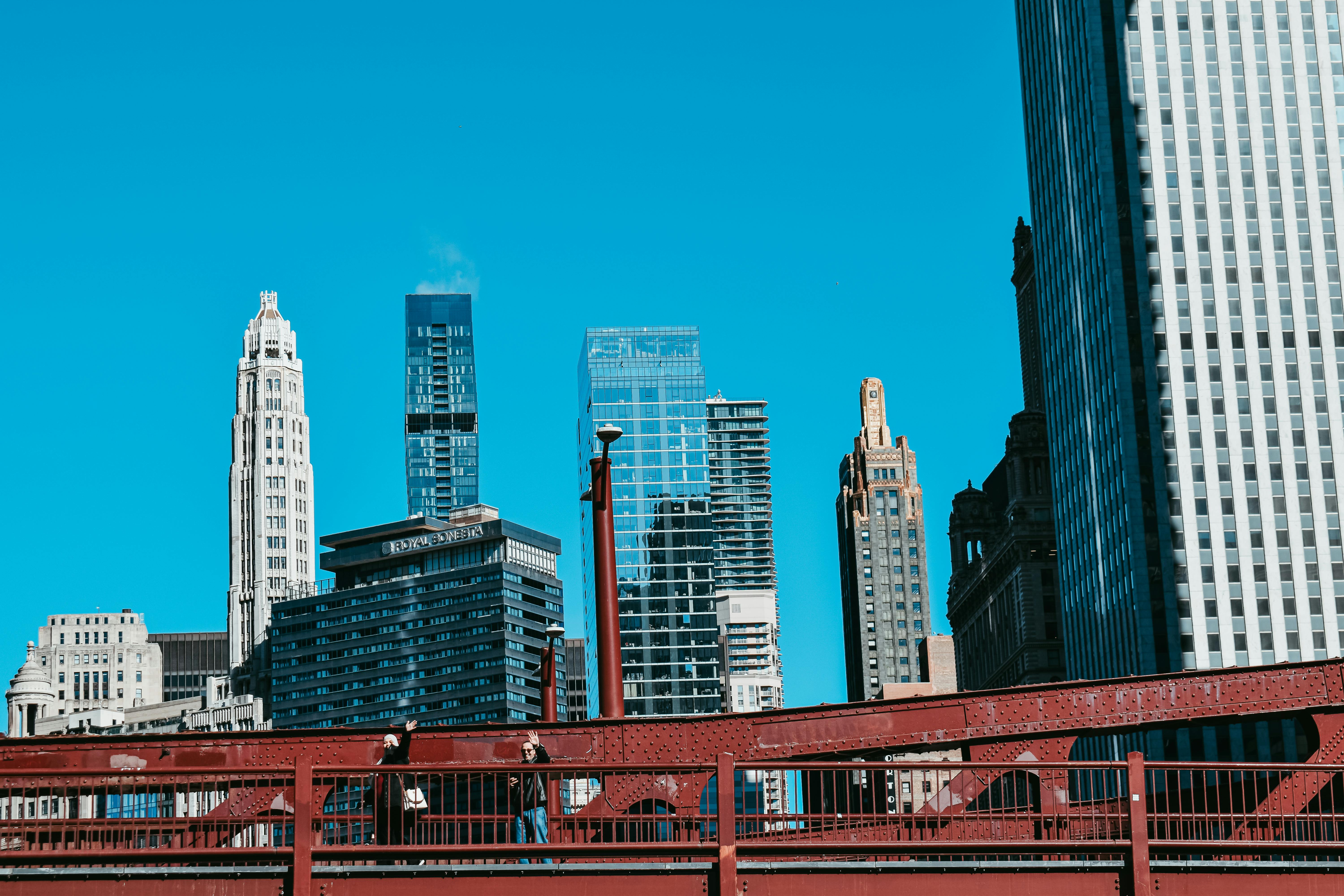 Chicago skyline with red steel bridge under blue sky