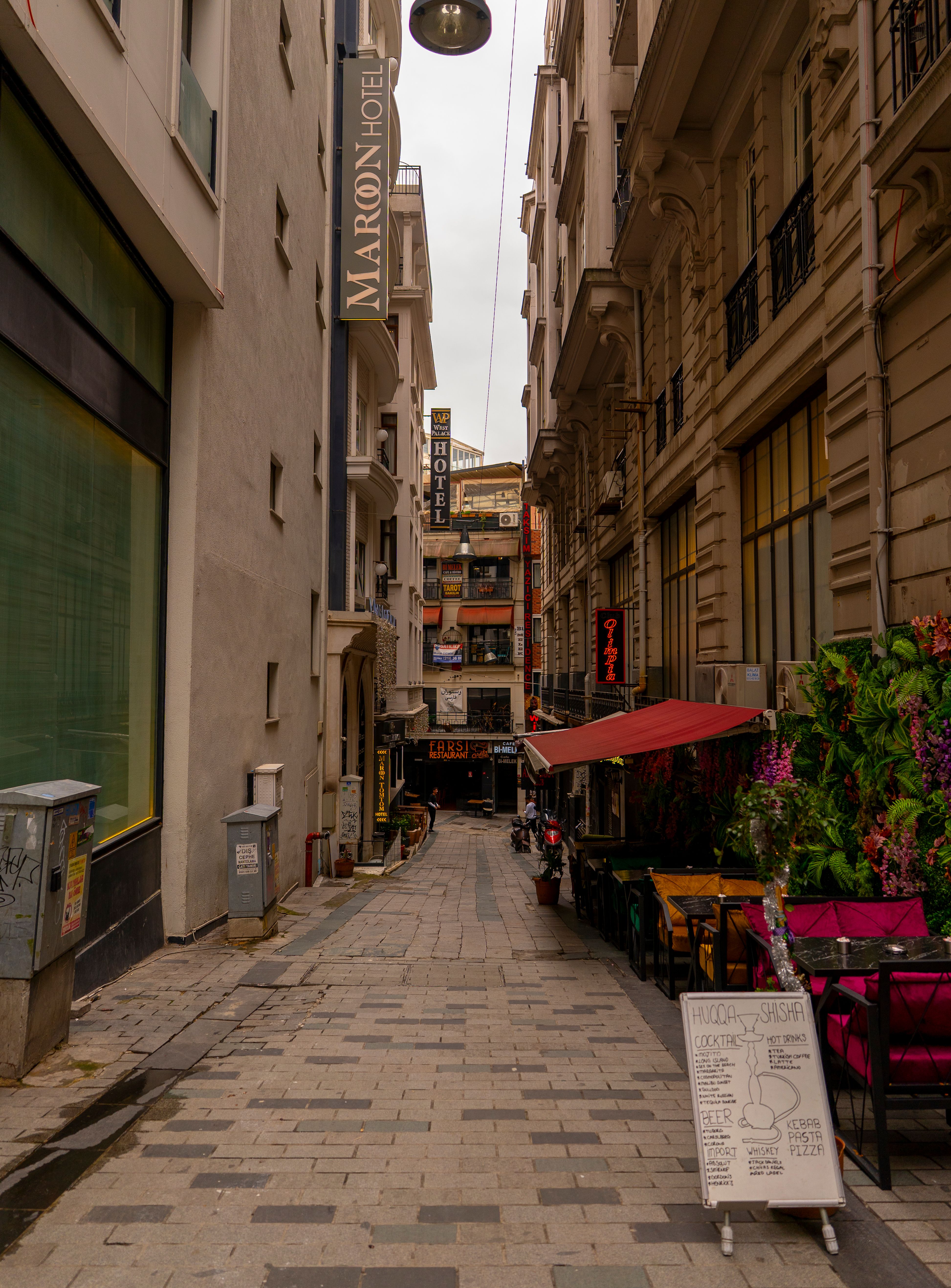 Explore a picturesque alleyway in Istanbul featuring quaint cafes and historic architecture, ideal for travel enthusiasts.