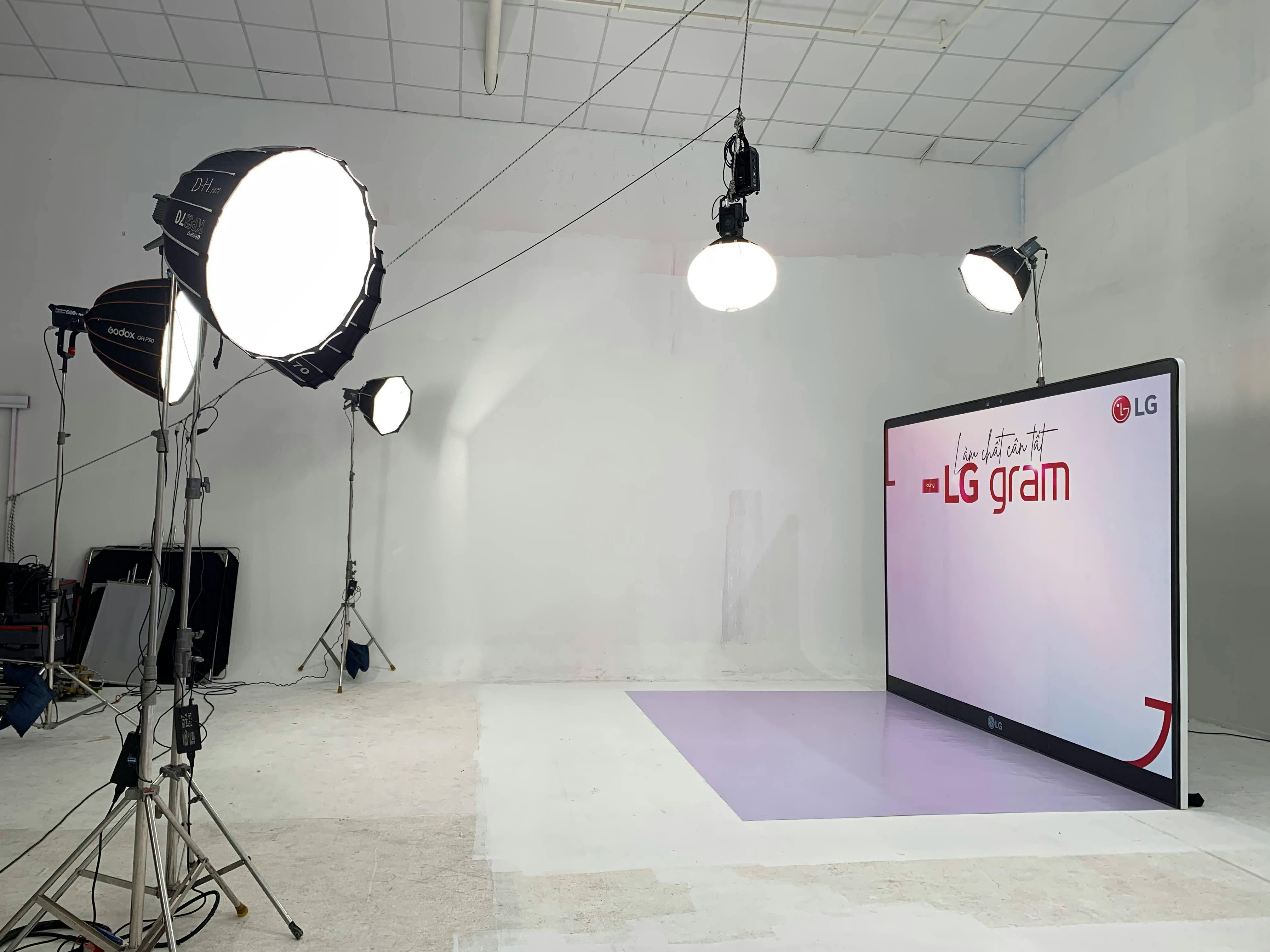 A modern photography studio setup with softbox lighting and LG Gram display, ideal for professional shoots.
