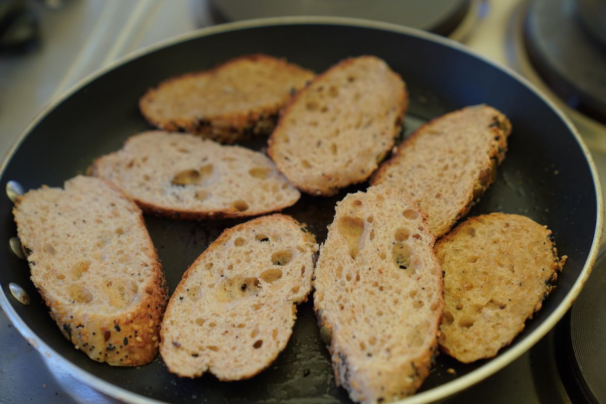 Golden slices of bread cooking in a nonstick frying pan