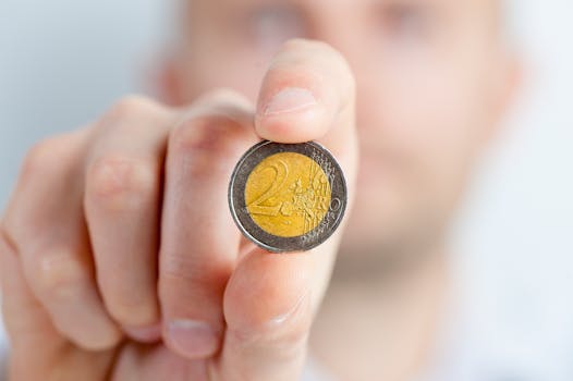 Person Holding a Gold and Silver Round Coin