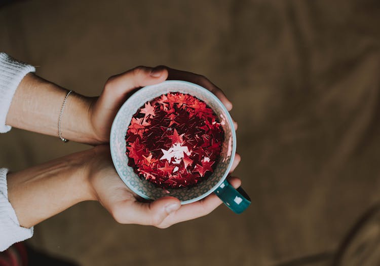 Photo Of Person Holding Cup Of Stars