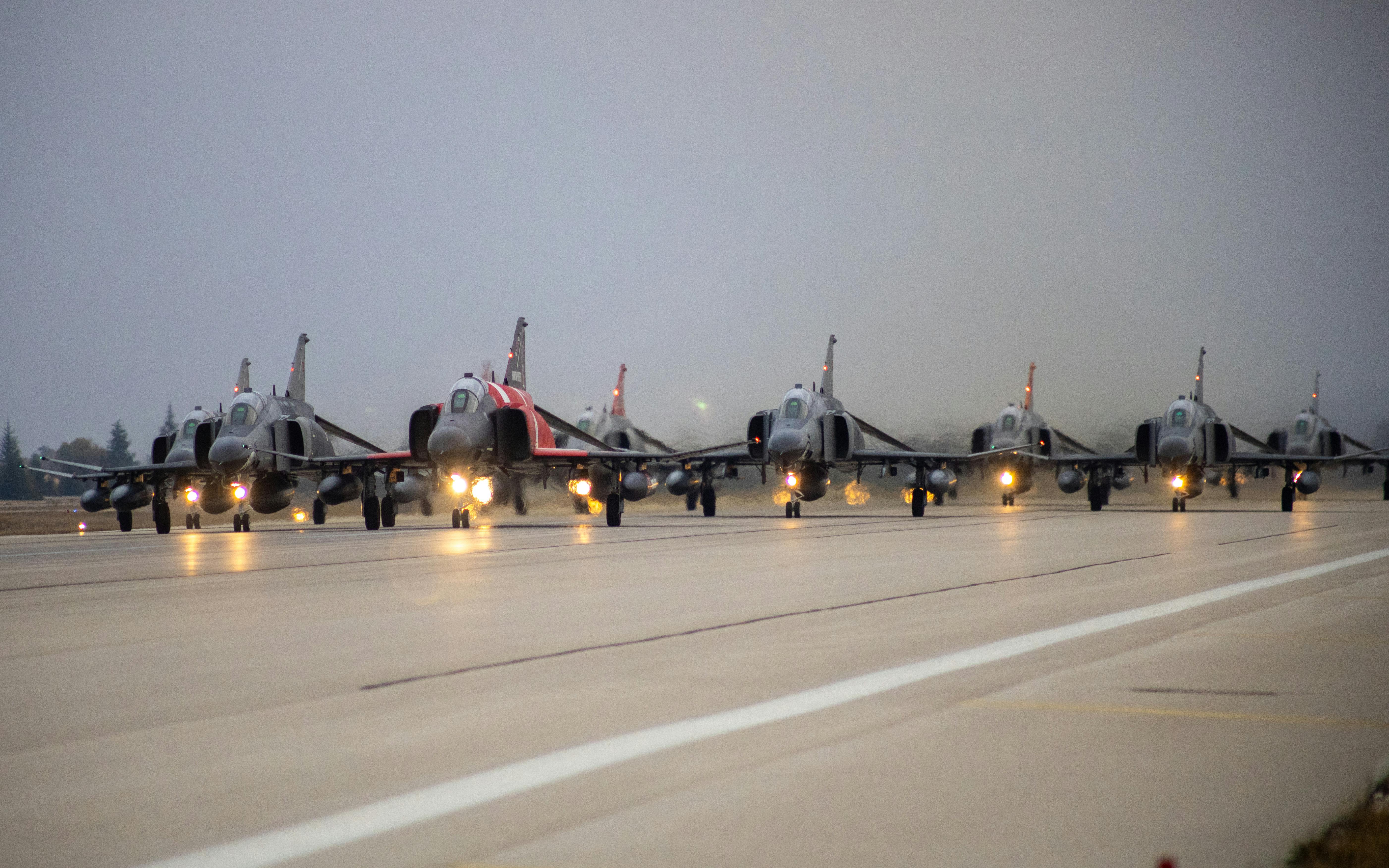 Fighter jets lined up on a runway in Eskişehir, Türkiye for a military operation.