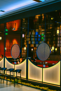 Stylish restaurant with modern decor and warm lighting, featuring unique circular designs.