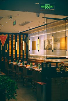 A cozy and inviting Asian restaurant interior featuring warm lighting and elegant decor.