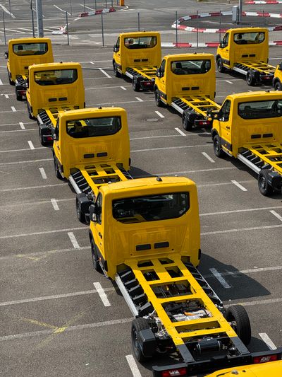 Yellow truck chassis neatly lined up showcasing industrial precision