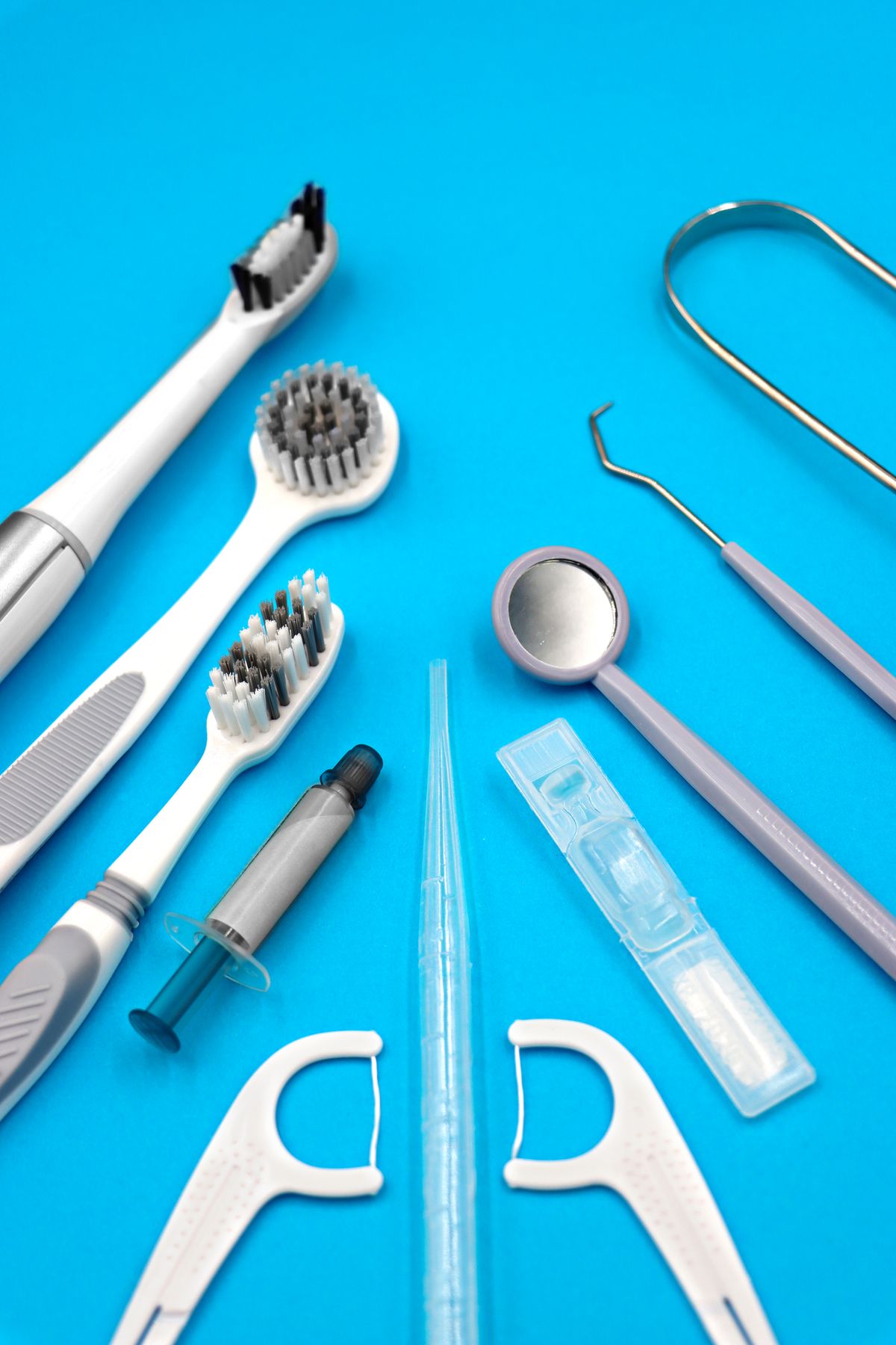 Essential Oral Hygiene Products on Blue Background · Free Stock Photo