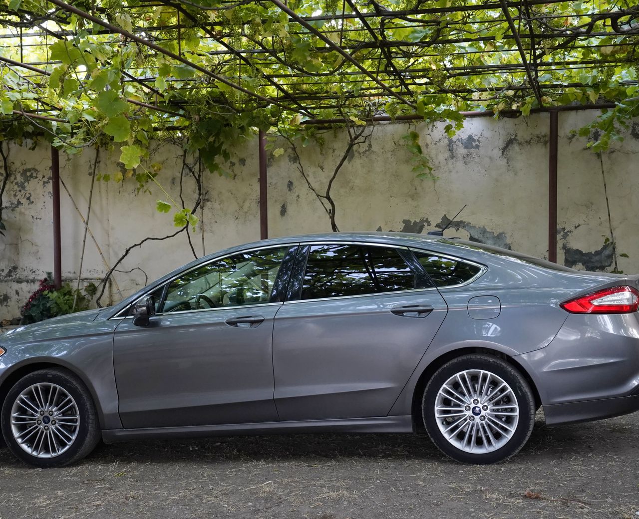 A clean silver sedan parked in the shade, side profile, ready for the next ride