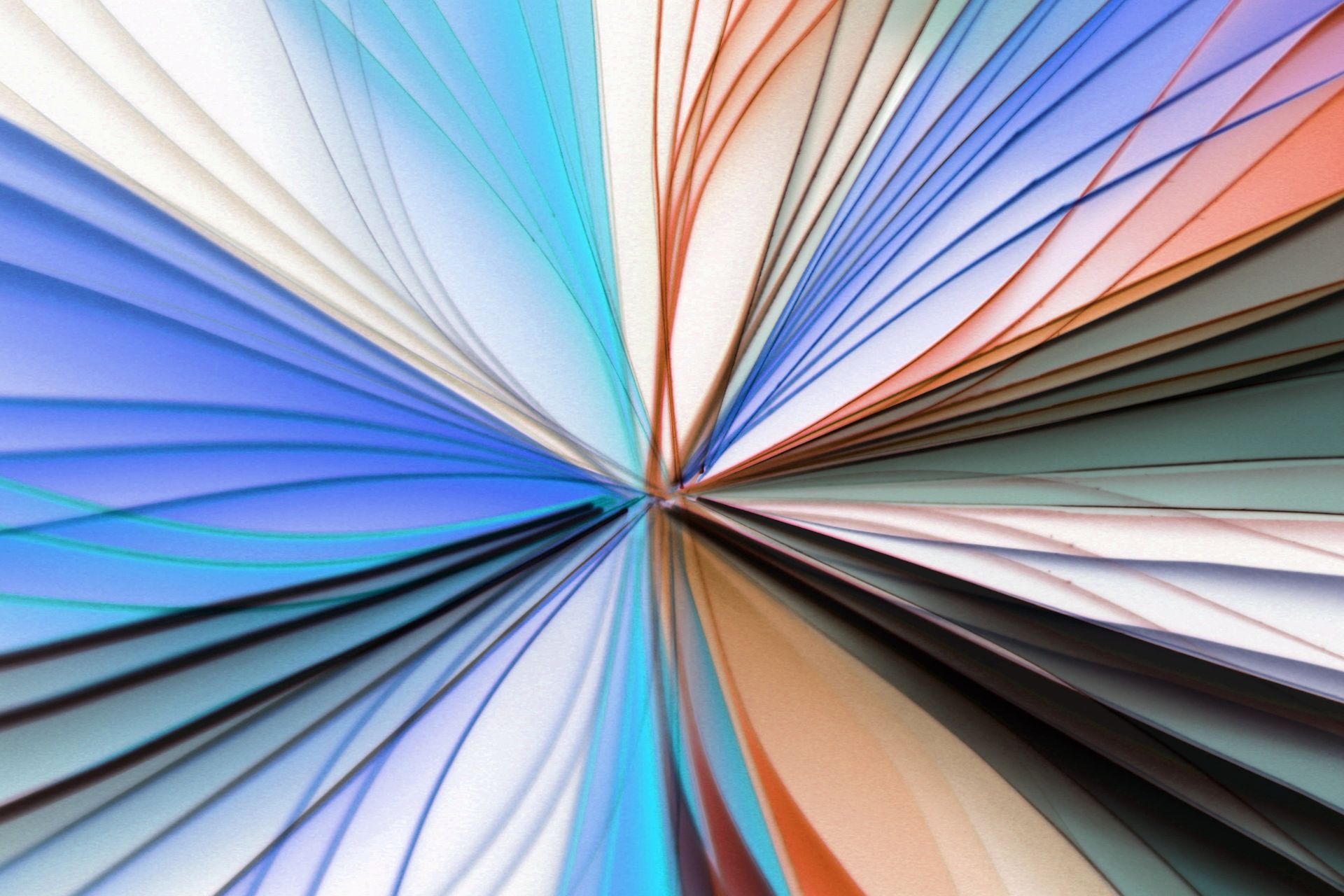 Vibrant abstract image of colorful paper fan design, exhibiting artistic form and symmetry.