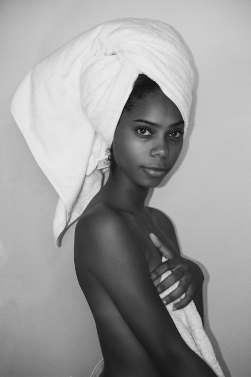 Grayscale Photo of Topless Woman Covered With Towel