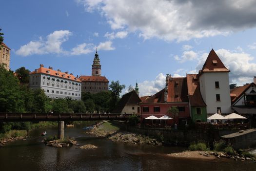 Charming Český Krumlov Castle and town by the Vltava River on a sunny day.