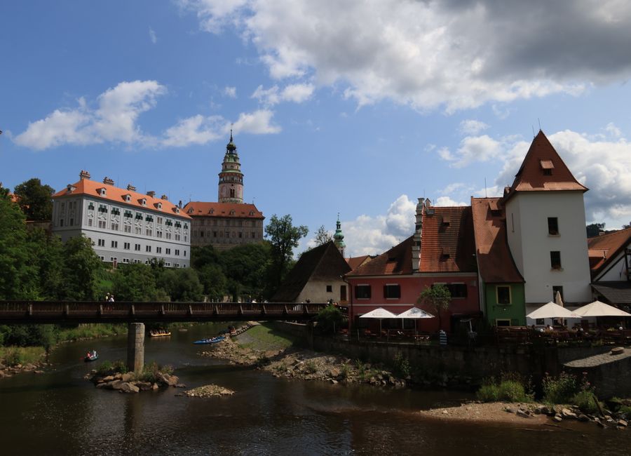 Charming Český Krumlov Castle and town by the Vltava River on a sunny day.