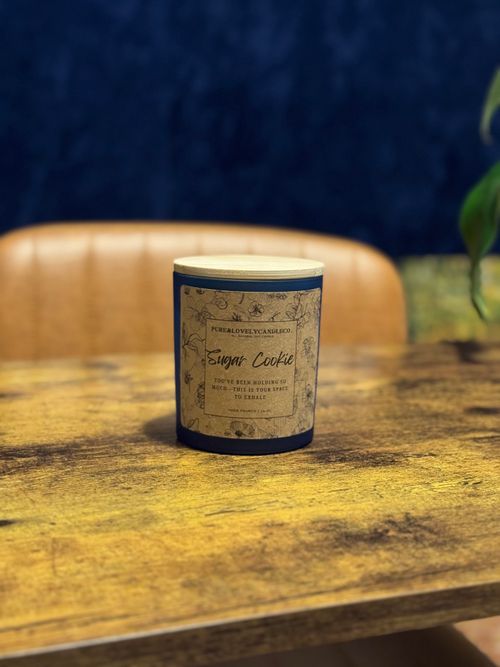 Free Sugar Cookie Candle Scent on Desk with Blue Wallpaper  Stock Photo