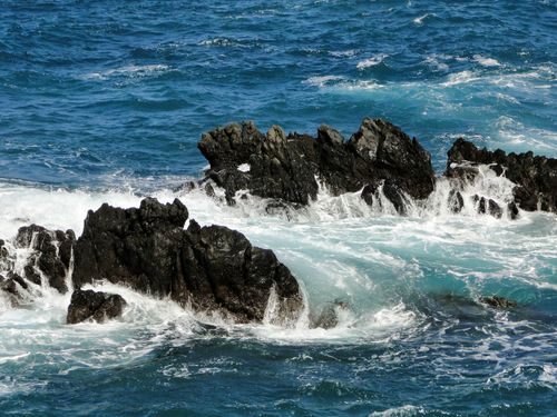 Free Dramatic view of volcanic rock formations surrounded by Atlantic Ocean waves in Porto Moniz, Madeira. Stock Photo