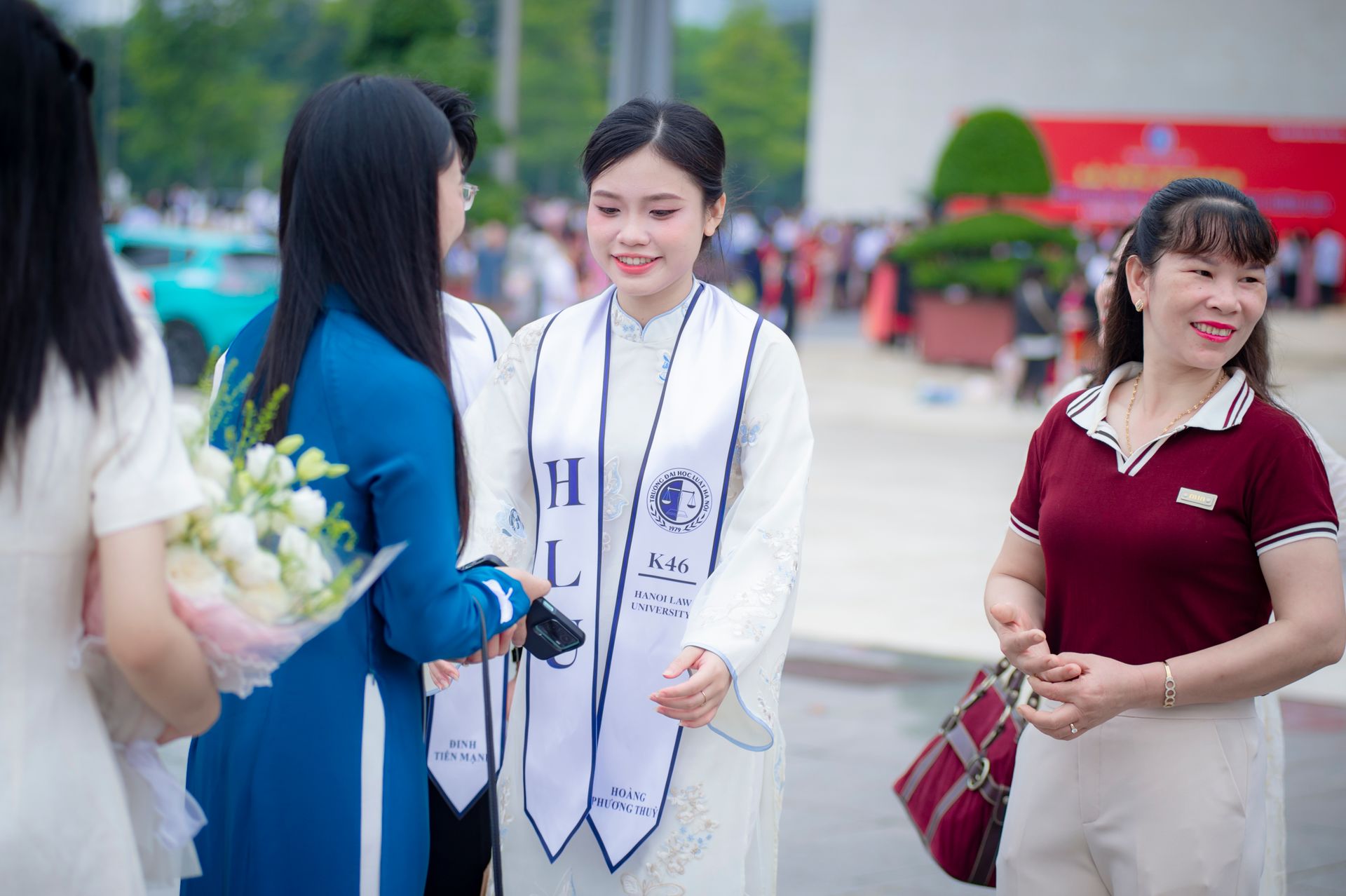 Graduates celebrate outdoors at Hanoi Law University, Vietnam.