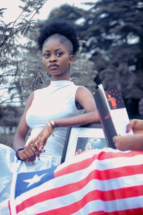 Young Woman Posing With Liberian Flag Outdoors Free Stock Photo Young Woman Posing With Liberian Flag Outdoors Free Stock Photo