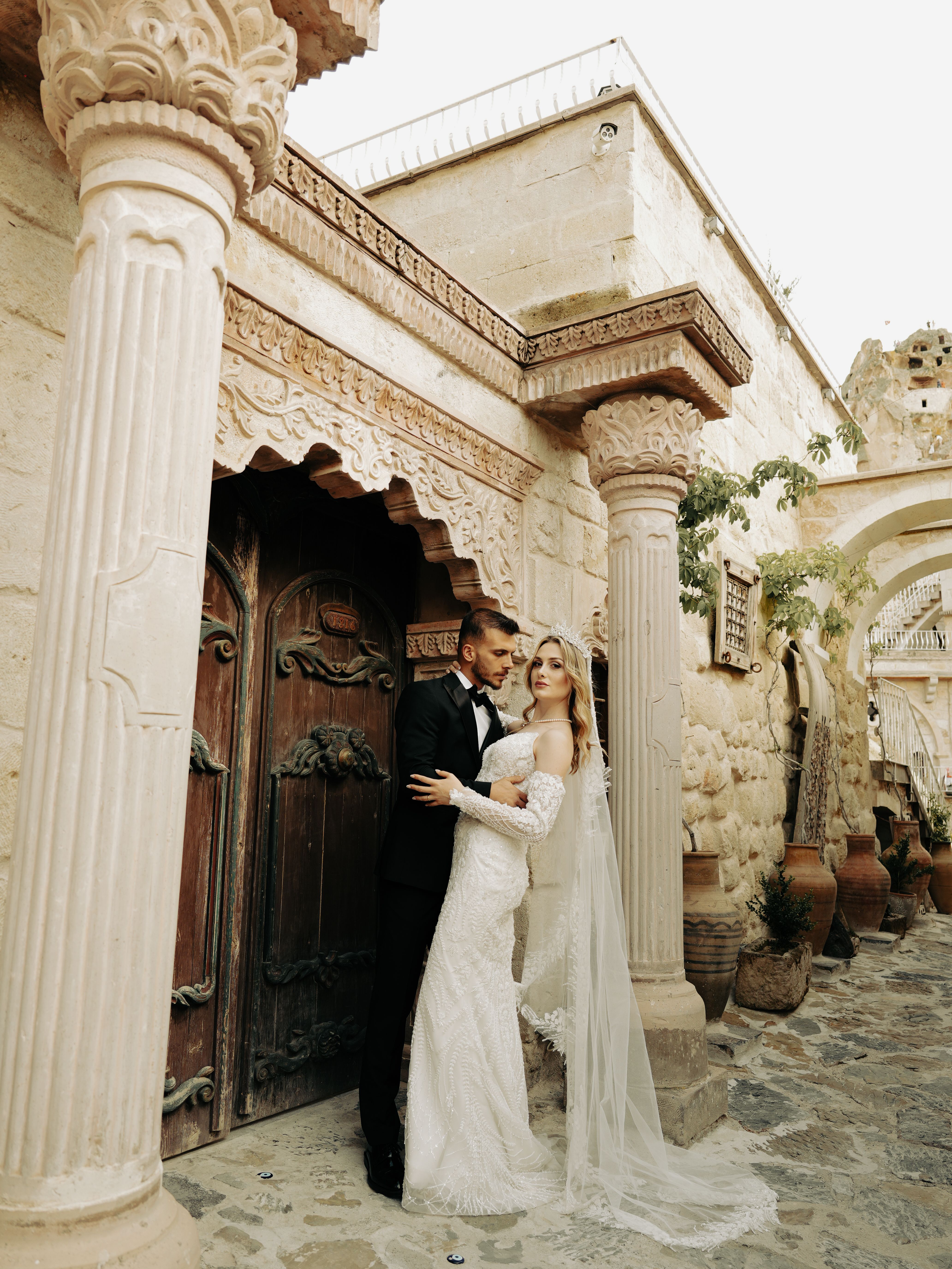 Elegant Wedding Couple in Rustic Stone Courtyard · Free Stock Photo