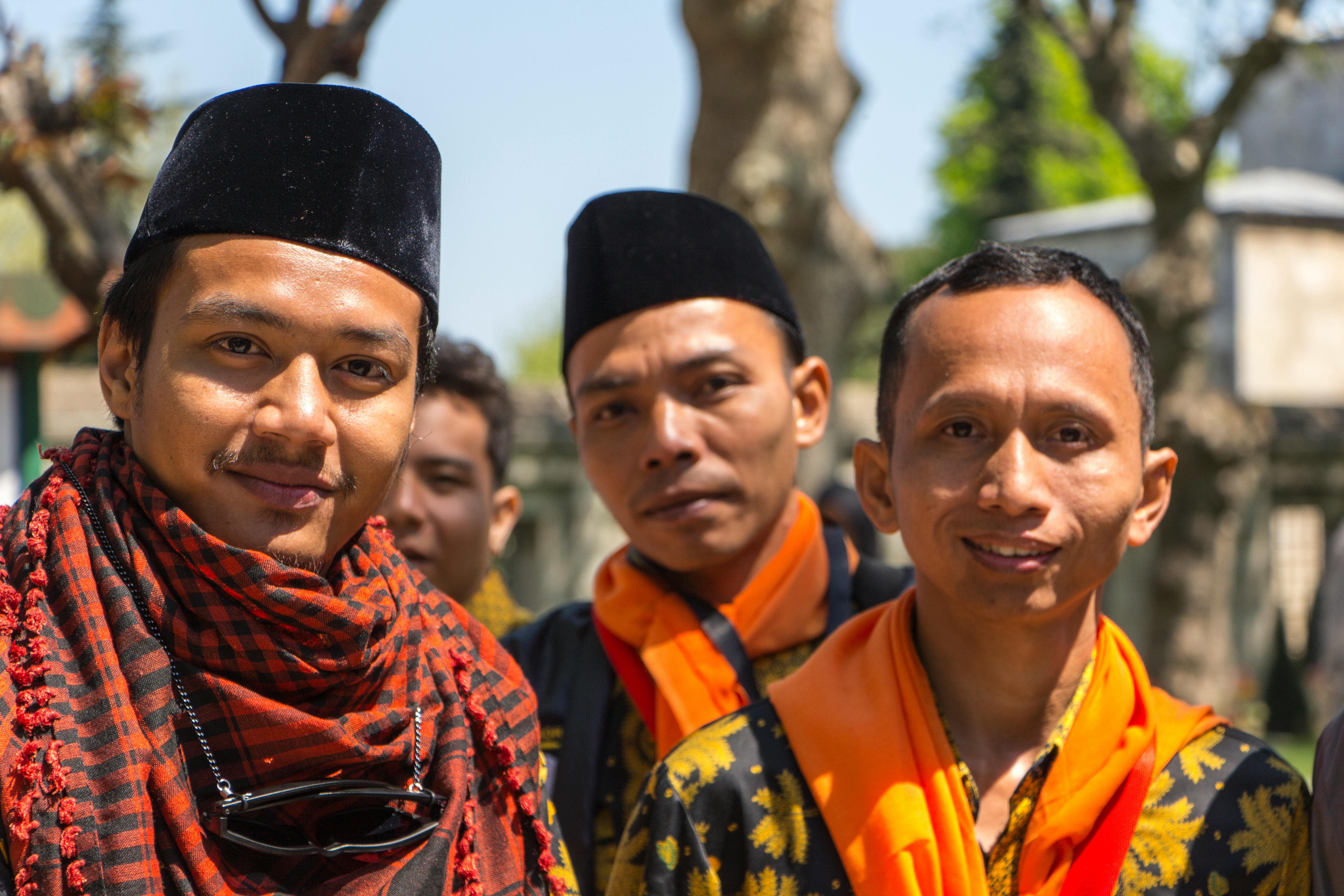 Group of Indonesian men wearing traditional clothing, showcasing cultural heritage.