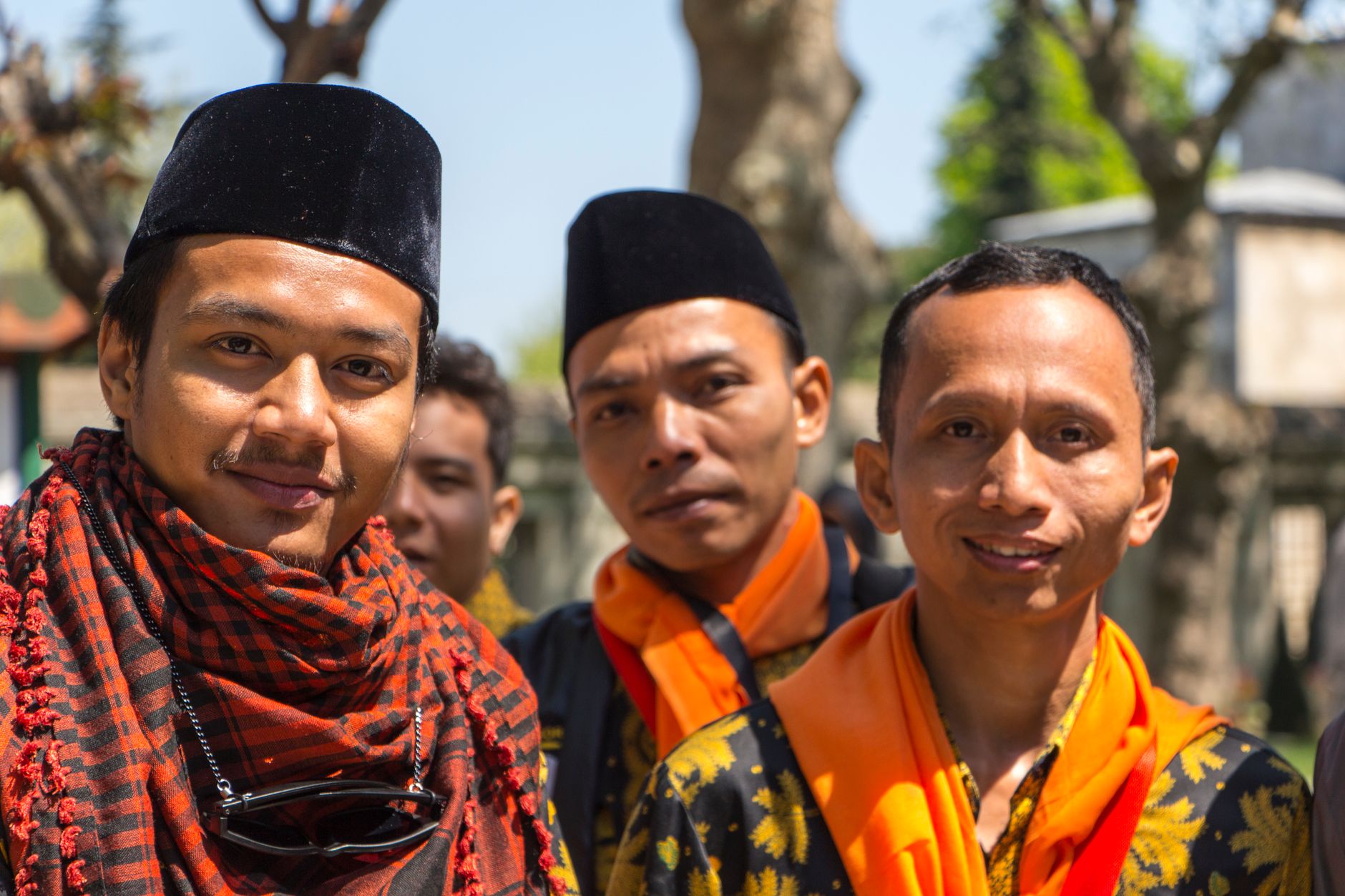 Group of Indonesian men wearing traditional clothing, showcasing cultural heritage.