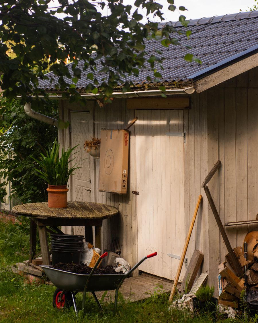 Garden shed assembled with tools and greenery