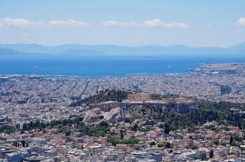 Free Stunning aerial panorama of Athens with the iconic Acropolis and the Aegean Sea in the background. Stock Photo