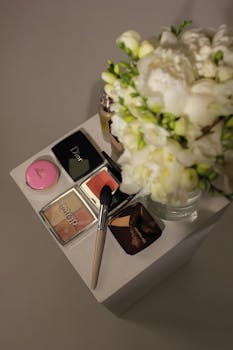 Stylish composition of cosmetics and white flowers on a table, perfect for beauty and fashion themes.