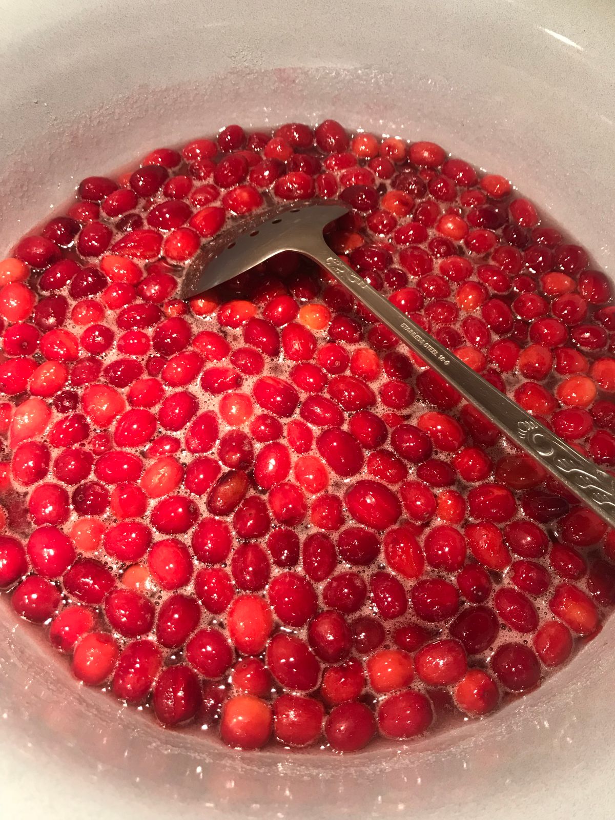 Fresh cranberries cooking in a pot for homemade cranberry sauce