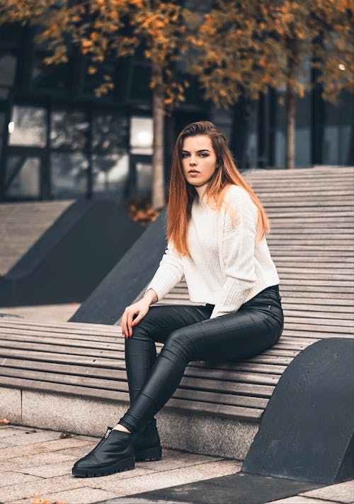 Photo Of Woman Sitting On Wooden Bench